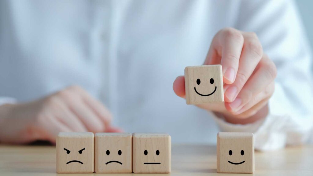 A person arranging wooden blocks with various facial expressions